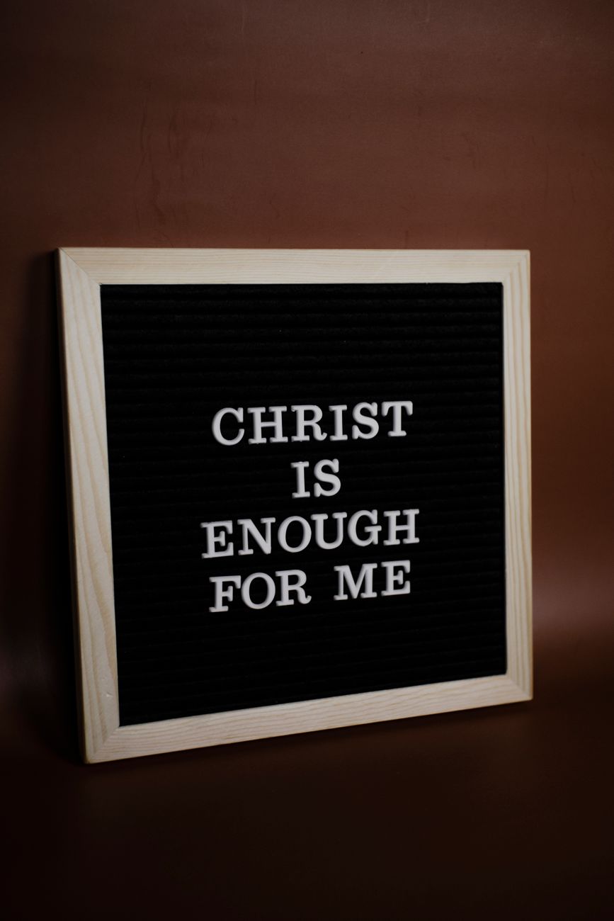 a letterboard leaning on a brown wall